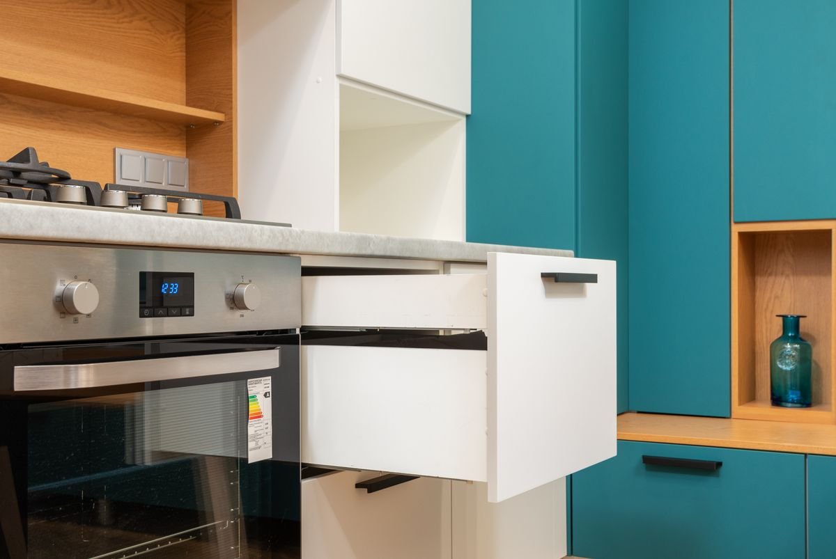 Kitchen drawer pulled fully open beside the oven