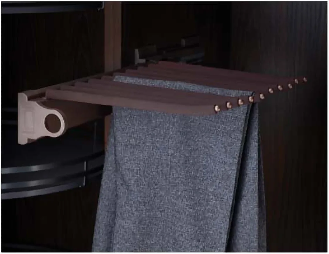 Side-mounted lateral pant rack holding trousers in a narrow wardrobe section