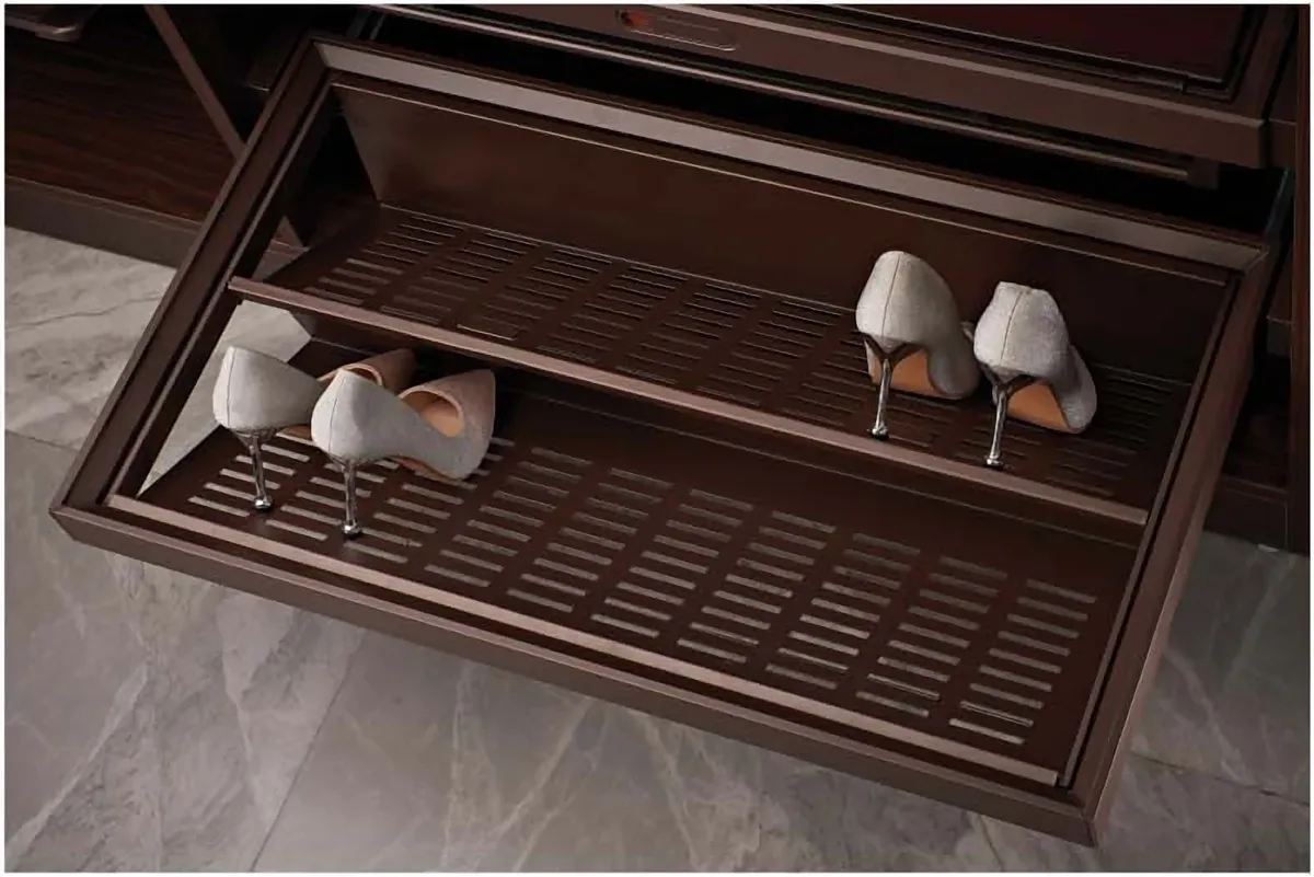 Pull-out shoe rack with shoes inside a wardrobe